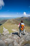 Walker at the summit of Slieve Bearnagh, Mourne Mountains, Co Down, Northern Ireland.