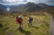 Walkers near the summit of Slievenaglogh, Mourne Mountains, Co Down, Northern Ireland.