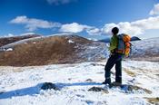 Winter walker on Ott Mountain, Mourne Mountains, Co Down, Northern Ireland.