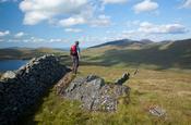 Walker looking towards the High Mournes from Pigeon Rock Mountain, Mourne Mountains, Co Down, Northern Ireland.
