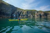 Sea kayaker beneath the cliffs of Howth Head, County Dublin, Ireland. image