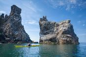Sea kayaker beneath the main gannet colony on Ireland's Eye, County Dublin, Ireland.