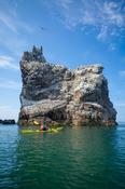 Sea kayaker beneath the main gannet colony on Ireland's Eye, County Dublin, Ireland. image