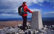 Walker at the summit of Cuilcagh Mountain, Co Fermanagh, Northern Ireland.