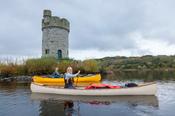 Canoeists beneath Crichton Tower, Crom Estate, Upper Lough Erne, County Fermanagh, Northern Ireland.