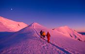 Mountaineers descending from Mont Blanc at sunset, French Alps, France.