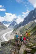 Hiking family above Mer de Glace glacier, Chamonix Valley, French Alps, France.