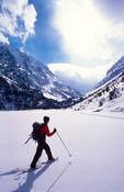 Snowshoeing across the frozen Lac de Gaube, Parc National des Pyrenees, France.