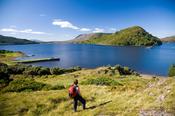 Walker looking over Lough Corrib and the Drumsnauv peninsula, Co Galway, Ireland.