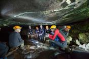 Guided caving group near the entrance of Ballymaclancy Cave, Cong, County Galway, Ireland.