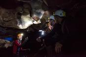 Guided caving group inside Ballymaclancy Cave, Cong, County Galway, Ireland.