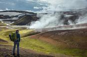 Hiker on the Laugavegur trail  beside Storihver hot springs, Hrafntinnusker. Central Highlands, Sudhurland, Iceland.