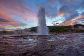 Strokkur geyser errupting at sunset. Geysir, Sudhurland, Iceland.