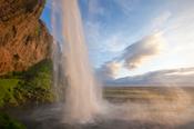 Seljalandsfoss waterfall plunging 60m from the cliff above, Sudhurland, Iceland.