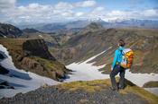 Hiker looking down Hvannargil valley from the Fimmvorduhals trail, Porsmork, Sudhurland, Iceland.