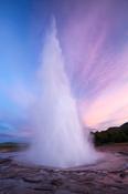 Strokkur geyser errupting at sunset, Geysir, Sudhurland, Iceland.