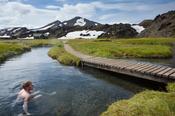 Swimmer enjoying the hot springs at Landmannalaugar, Sudhurland, Iceland.
