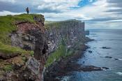 Person on top of the Latrabjarg bird cliffs. Latrabjarg Peninsula, Westfjords, Iceland.