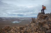 Hiker looking across the Glama plateau from the 752m summit of Lomfell mountain. Westfjords, Iceland.