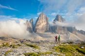 Hikers beneath Tre Cime di Lavaredo, Sexten Dolomites, South Tyrol, Italy.