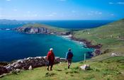 Walkers approaching Slea Head on the Dingle Way, Co Kerry, Ireland.