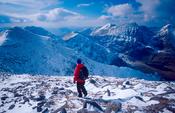 Winter walker heading west from Knocknapeasta, MacGillycuddy's Reeks, Co Kerry, Ireland.