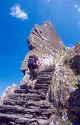 Walker climbing the stone stairway of Skellig Michael, Co Kerry, Ireland.