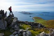 Walker looking across Slea Head and the Blasket Islands from Eagle Mountain, County Kerry, Ireland.