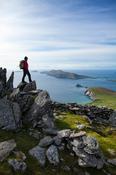 Walker looking across Slea Head and the Blasket Islands from Eagle Mountain, County Kerry, Ireland. image