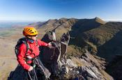 Rock climber and pinnacle on Howling Ridge, Carrauntoohil, MacGillycuddy's Reeks, County Kerry, Ireland.