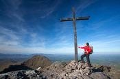 Walker at the summit of Carrauntoohil, MacGillycuddy's Reeks, County Kerry, Ireland.