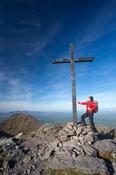 Walker at the summit of Carrauntoohil, MacGillycuddy's Reeks, County Kerry, Ireland.