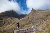 Hiker beneath Carrauntoohil from Lough Gouragh, MacGillycuddy's Reeks, County Kerry, Ireland.