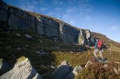 Walker beneath the Slieve Anierin escarpment, Co Leitrim, Ireland.