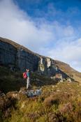 Walker beneath the Slieve Anierin escarpment, Co Leitrim, Ireland. image