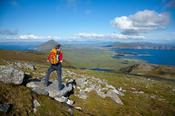 Walker looking over Achill Island from Croaghaun, Co Mayo, Ireland. image