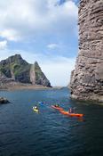 Sea kayakers passing Hag Island, North Mayo seacliffs, Co Mayo, Ireland.