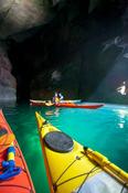 Sea kayakers in a cave near Doonamoe Point, Belmullet, County Mayo, Ireland.