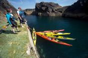 Sea kayakers landing on Eagle Island, Belmullet, County Mayo, Ireland.