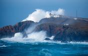 Storm waves crash 75m high above Eagle Island Lighthouse, Belmullet, County Mayo, Ireland.