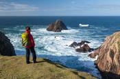 Walker at the tip of Erris Head, Belmullet, County Mayo, Ireland.