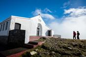 Walkers besite the church at the summit of Croagh Patrick, County Mayo, Ireland.
