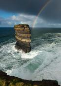 Rainbow and storm waves surround Dun Briste seastack, Downpatrick Head, County Mayo, Ireland. image