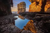 Dun Briste sea stack framed by a cave beneath Downpatrick Head. County Mayo, Ireland. image