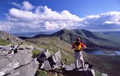 Walker near the summit of Glennamong, Nephin Beg Mountains, Co Mayo, Ireland.