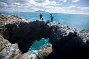 Standing on top of a sea arch, Dooega Head, Achill Island, Co Mayo, Ireland. image
