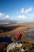 Walker looking to Achill Island from Corraun Hill, Co Mayo, Ireland. image