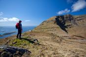 Walker looking across the east face of Mweelrea, Co Mayo, Ireland.