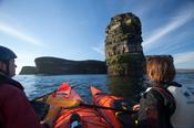 Sea kayakers admiring Dun Briste seastack, Downpatrick Head, Co Mayo, Ireland.