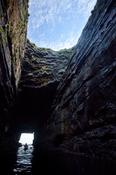 Sea kayaker in the cave beneath Downpatrick Head, Co Mayo, Ireland.